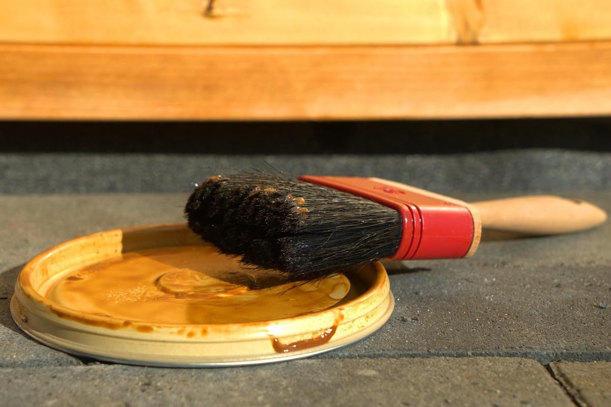 Un pinceau reposant sur un couvercle de pot de peinture Un pinceau reposant sur un couvercle de pot de peinture